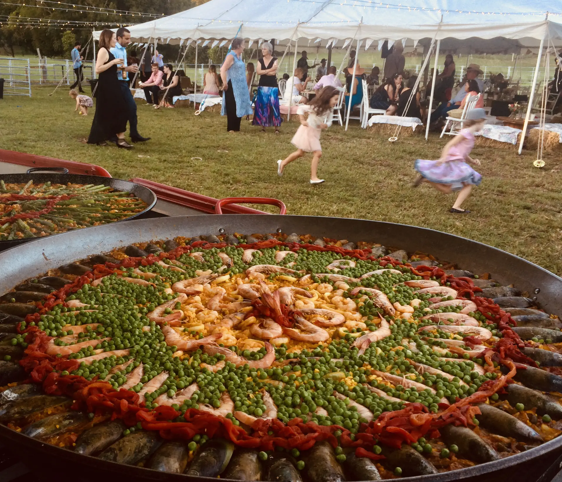 Wedding catering with a large paella dish ready to serve guests